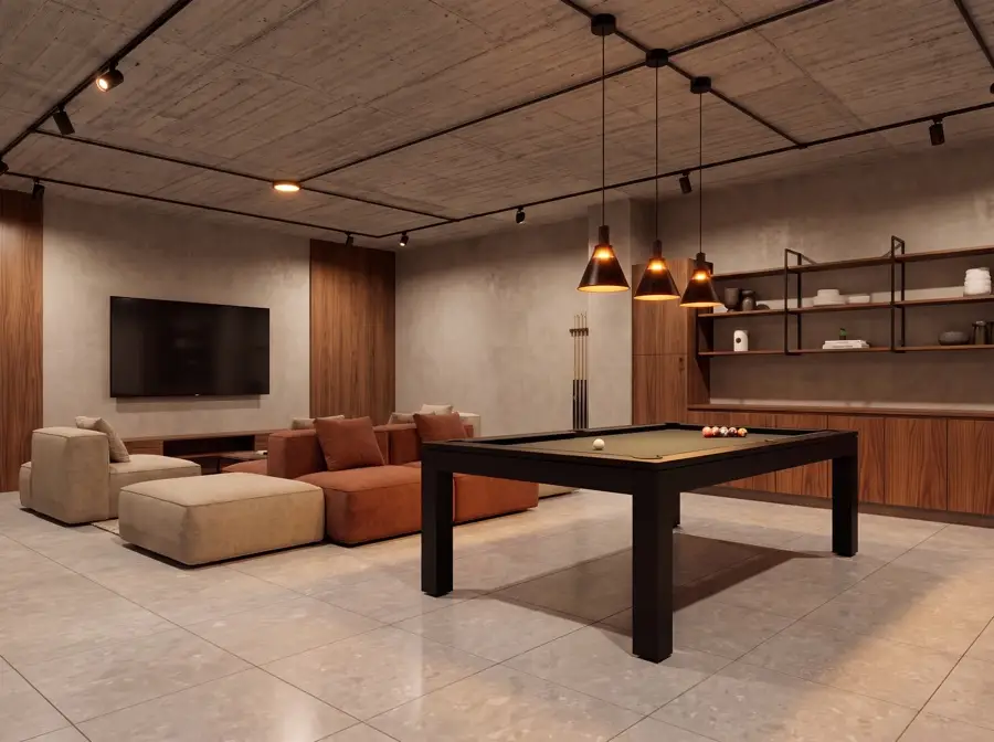 Sala de juegos con mesa de billar, sofás terracota y pantalla en muro